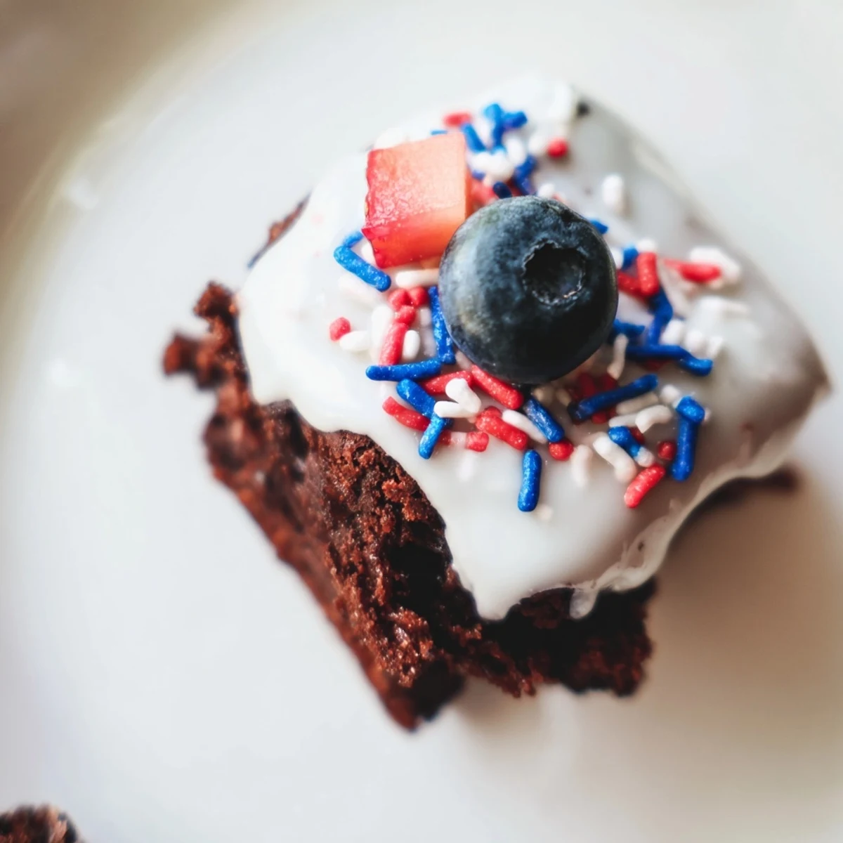 Festive Fourth of July Brownie Bites topped with red and blue sprinkles for a patriotic treat.