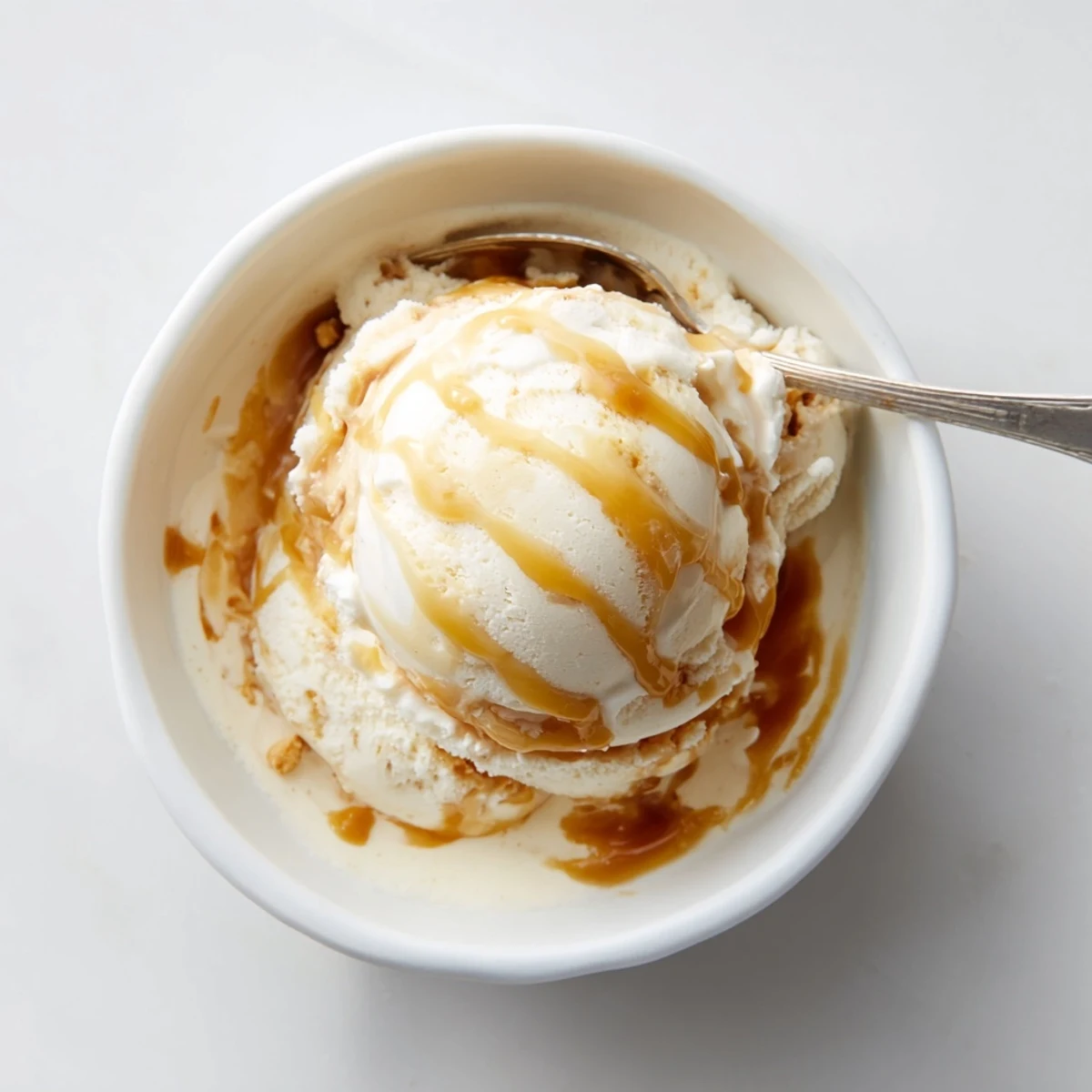 Rich scoops of creamy salted caramel ice cream with golden caramel swirls.  