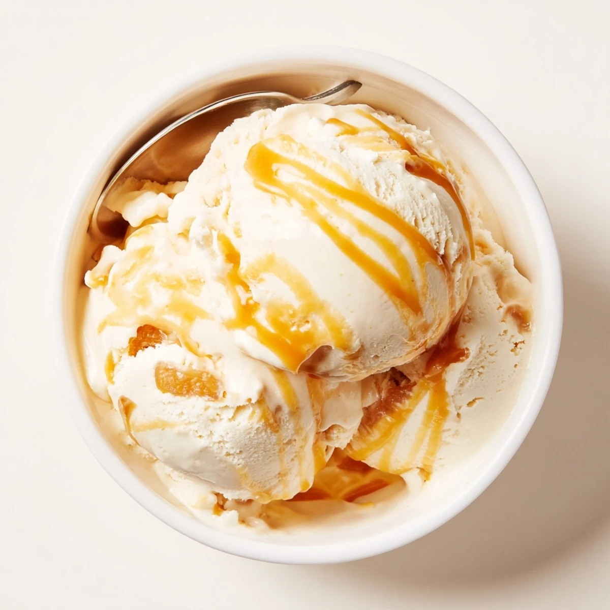 Smooth no churn salted caramel ice cream served in a chilled bowl.  