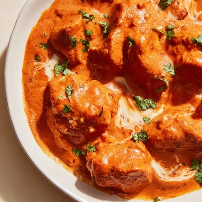 Tender chicken pieces simmered in rich spiced tomato sauce finished with heavy cream