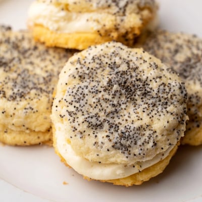 Soft lemon poppy seed cheesecake cookies with bright citrus zest and speckled poppy seeds, dusted in sparkling sugar