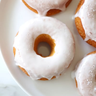 Light and fluffy Greek yogurt cake donuts sprinkled with colorful toppings on a wire rack