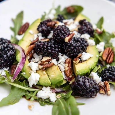 Vibrant blackberry avocado salad featuring ripe berries, crunchy pecans, and zesty lime dressing  