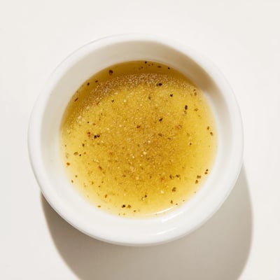 Creamy honey vinaigrette whisked in a glass jar ready for salads  
