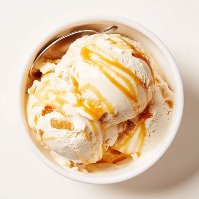 Smooth no churn salted caramel ice cream served in a chilled bowl.  